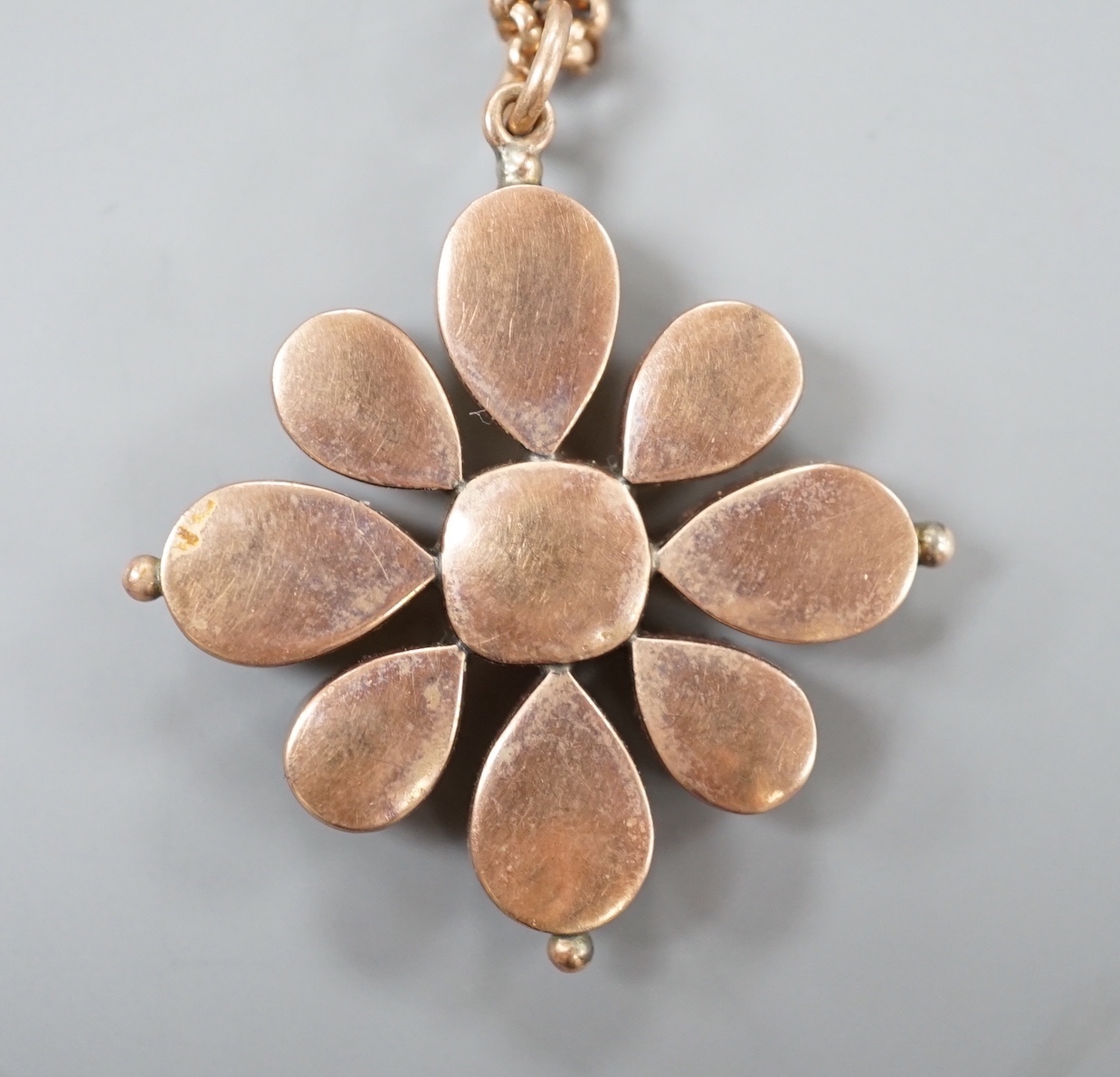 A 19th century yellow metal and foil backed paste set pendant, 42mm, on a later 375 chain, gross weight 12.9 grams.